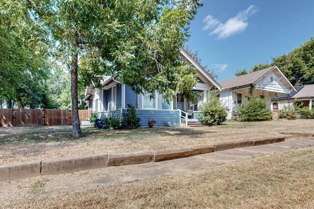 obstructed view of property with a front yard