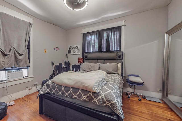 bedroom featuring light hardwood / wood-style flooring and cooling unit