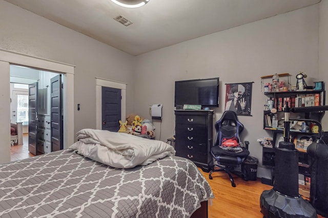 bedroom with hardwood / wood-style flooring