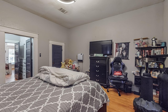 bedroom with wood finished floors and visible vents