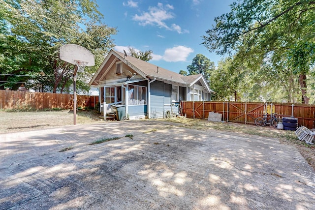 rear view of property featuring a sunroom