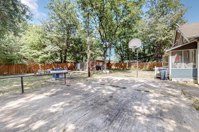 view of yard with a sunroom and a fenced backyard