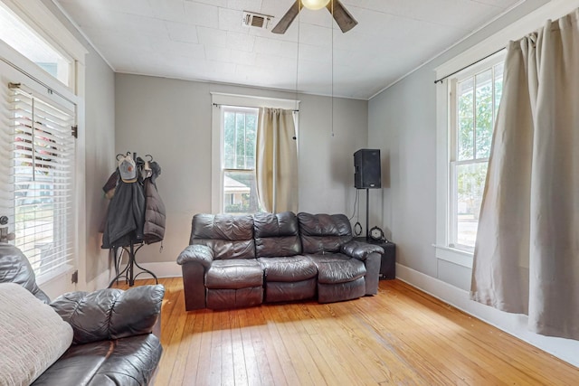 living room with ceiling fan, light hardwood / wood-style flooring, and ornamental molding