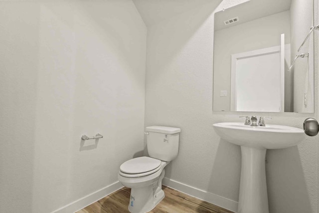 bathroom with sink, hardwood / wood-style flooring, and toilet