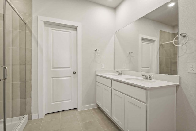 bathroom with vanity, tile patterned flooring, and a shower with door