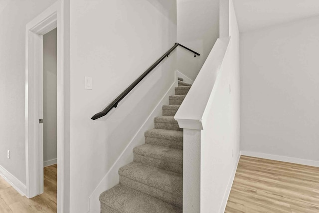 staircase featuring hardwood / wood-style floors