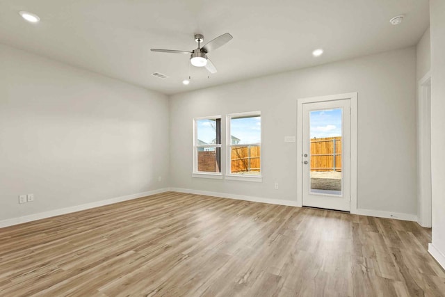 unfurnished room with ceiling fan and light wood-type flooring