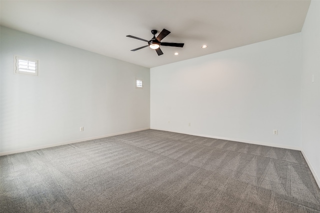 carpeted spare room featuring ceiling fan