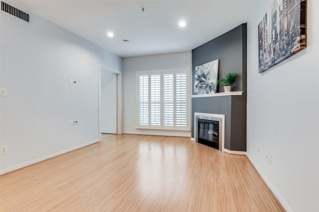 unfurnished living room with light hardwood / wood-style floors