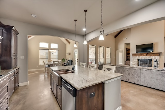 kitchen with dishwasher, a kitchen island with sink, vaulted ceiling with beams, hanging light fixtures, and dark brown cabinetry