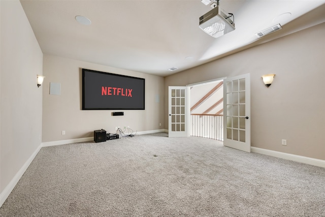 carpeted home theater with french doors