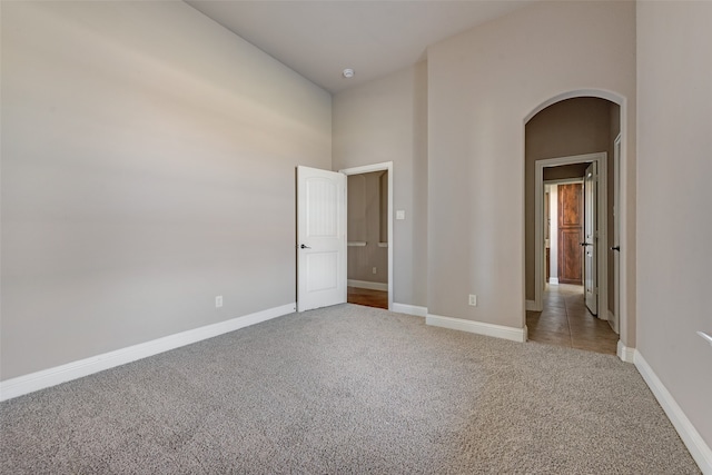 unfurnished room featuring light carpet