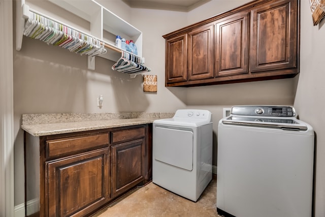 laundry room with cabinets and washing machine and clothes dryer