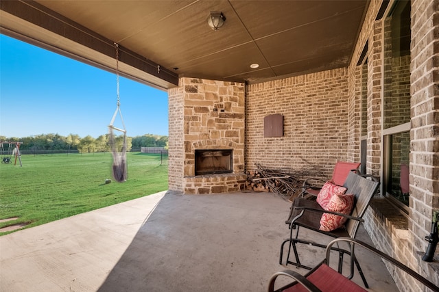 view of patio / terrace featuring an outdoor stone fireplace