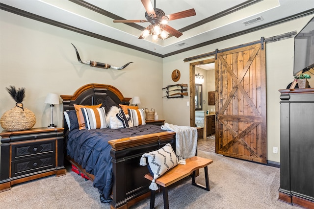 carpeted bedroom with ceiling fan, a raised ceiling, crown molding, and a barn door