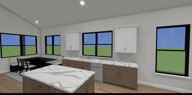 kitchen featuring light wood-type flooring, stainless steel dishwasher, white cabinetry, and a kitchen island