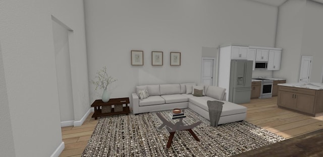 living room featuring a towering ceiling and light wood-type flooring