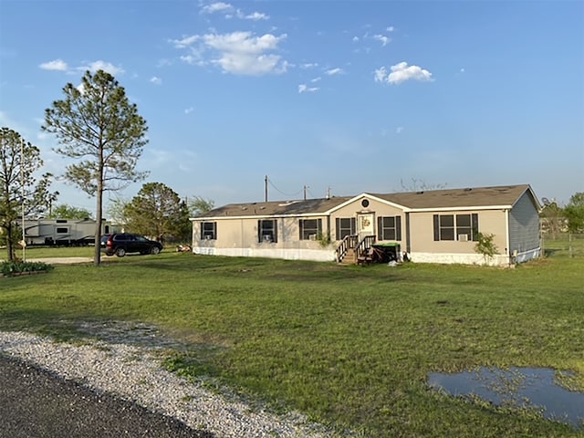 back of property featuring a yard