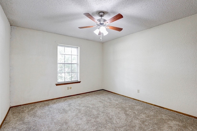 unfurnished room with ceiling fan, a textured ceiling, and carpet