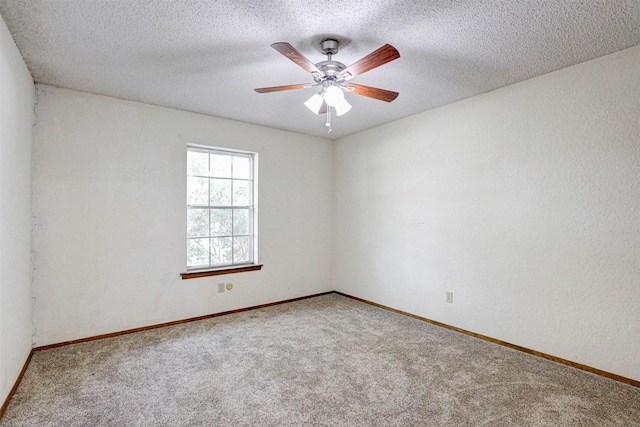 spare room featuring a textured ceiling, a ceiling fan, carpet flooring, and a textured wall