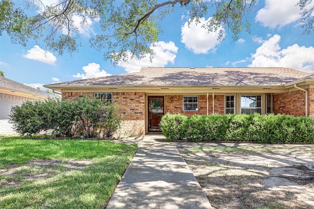 ranch-style home featuring a front yard