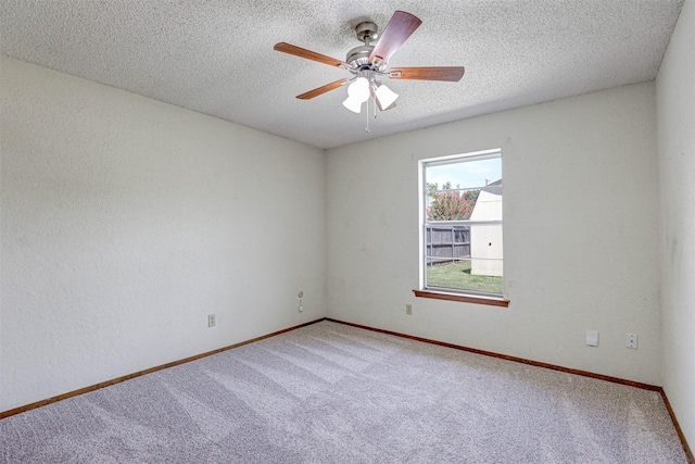 empty room with baseboards, a textured ceiling, a ceiling fan, and carpet flooring