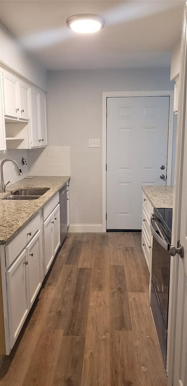 kitchen featuring white cabinets, stainless steel dishwasher, black / electric stove, and sink