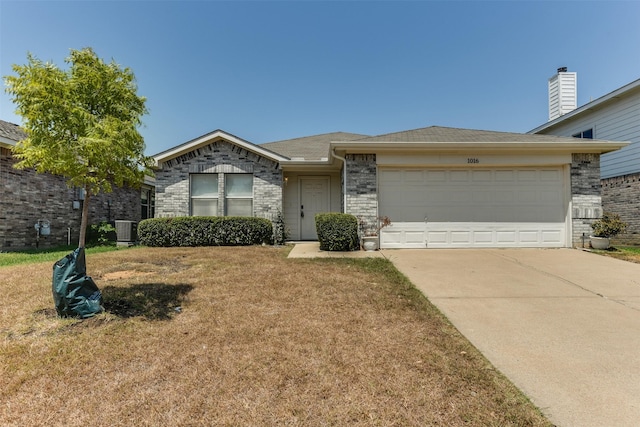 view of front of property featuring brick siding, concrete driveway, central AC, a garage, and a front lawn