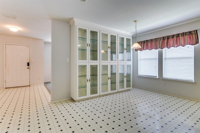 unfurnished dining area featuring light floors, visible vents, and baseboards