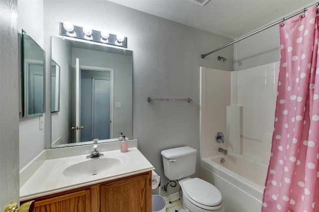 full bath featuring a textured wall, vanity, toilet, and shower / bath combo with shower curtain