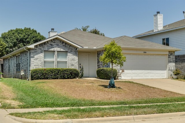 view of front of home with a garage and a front lawn