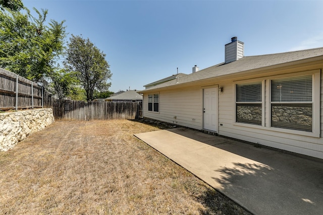 view of yard featuring a patio area and a fenced backyard