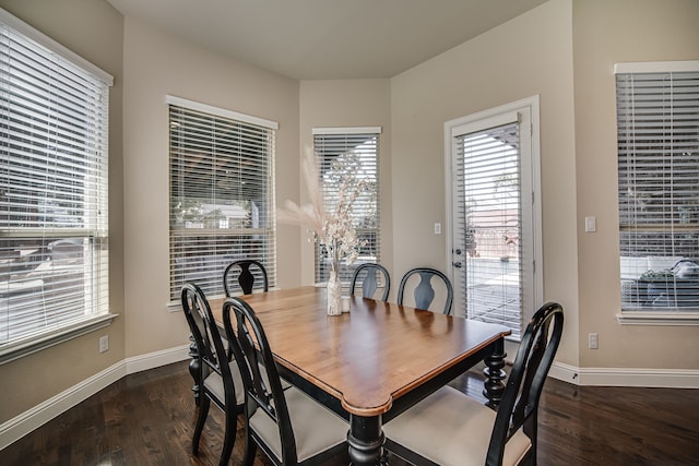 dining space with dark hardwood / wood-style floors