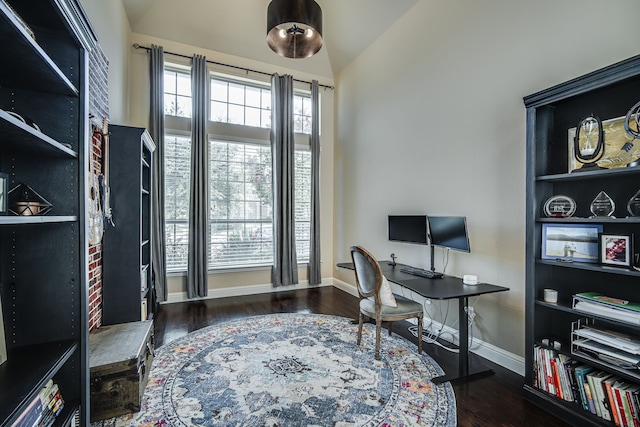 office with lofted ceiling and dark wood-type flooring