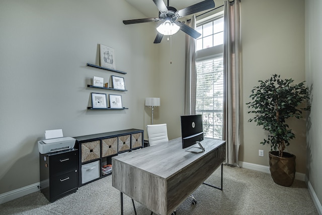 office space featuring ceiling fan and light carpet