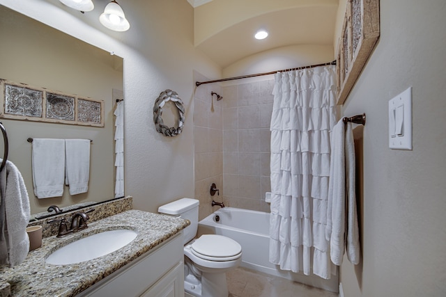 full bathroom featuring vanity, shower / bath combo, and toilet