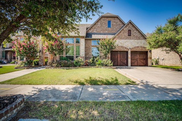 view of front facade with a garage and a front lawn