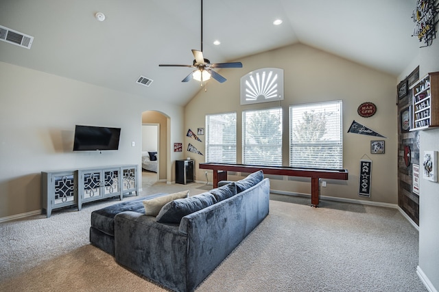 living room with ceiling fan, light colored carpet, and vaulted ceiling