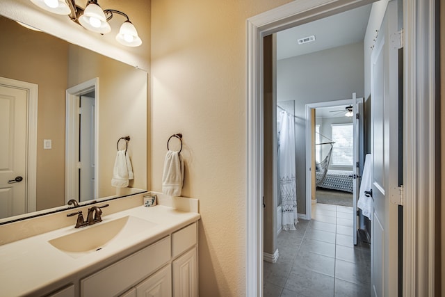 bathroom featuring tile patterned floors, ceiling fan, and vanity