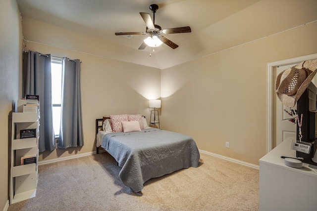 bedroom featuring ceiling fan, light carpet, and lofted ceiling