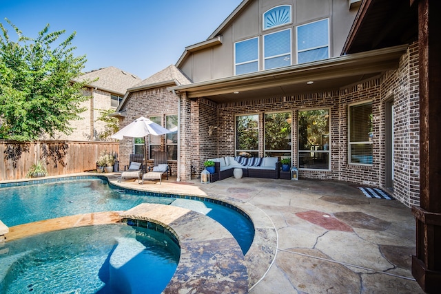 view of pool featuring an in ground hot tub, a patio, and an outdoor hangout area