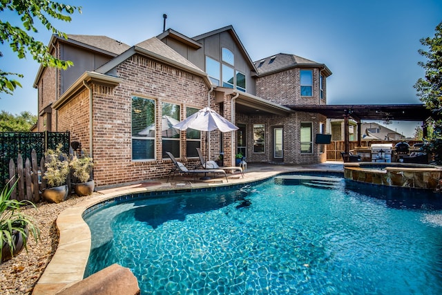 view of swimming pool with a patio area and an in ground hot tub