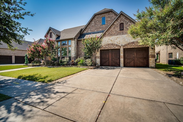 view of front facade with a garage and a front lawn