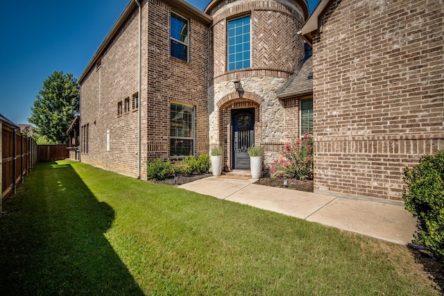 property entrance with a lawn