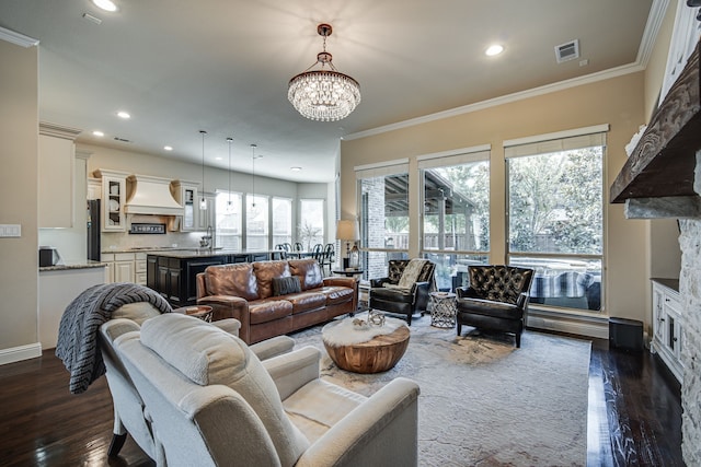 living room with ornamental molding, dark hardwood / wood-style floors, and a notable chandelier