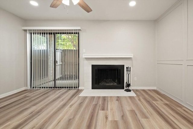 unfurnished living room featuring a fireplace with flush hearth, wood finished floors, recessed lighting, baseboards, and ceiling fan