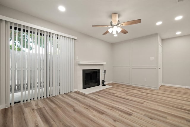 unfurnished living room featuring light hardwood / wood-style floors and ceiling fan