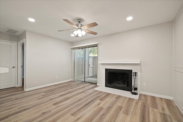 unfurnished living room featuring ceiling fan and light hardwood / wood-style floors