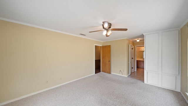 unfurnished room featuring light colored carpet, visible vents, ornamental molding, a ceiling fan, and baseboards