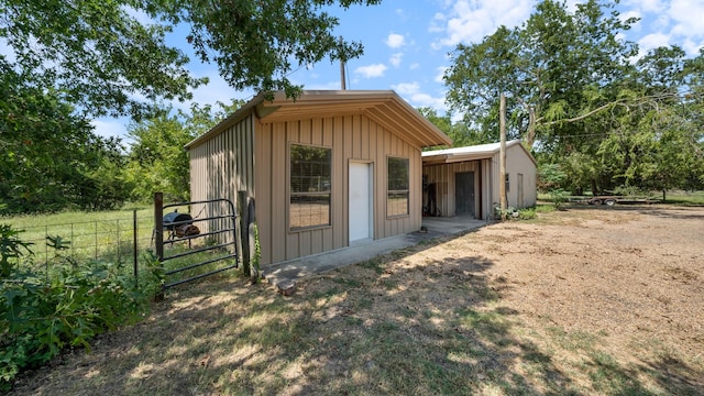 view of outbuilding with an outbuilding and fence